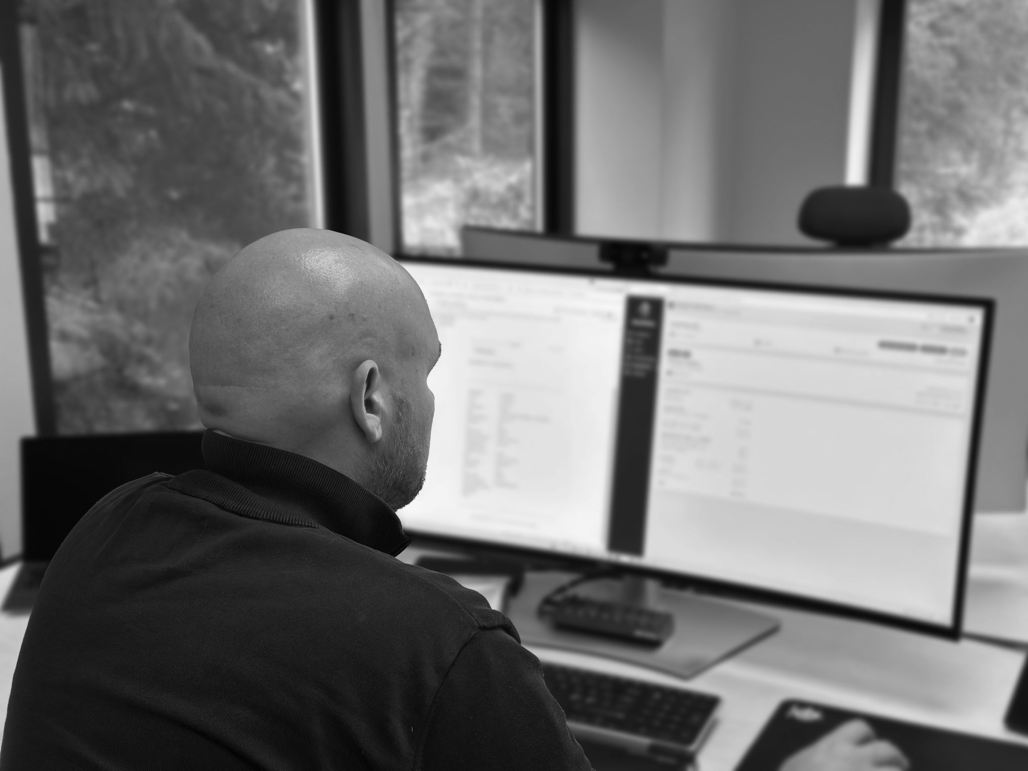 A utility worker in front of a computer.